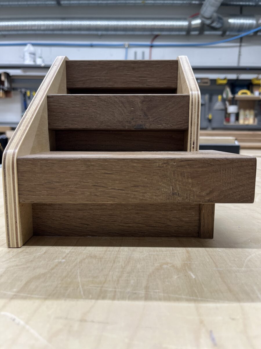 Close-up of hardwood stair nosing on sample staircase showing milling quality.